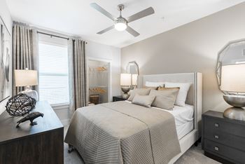 a bedroom with a bed and a ceiling fan